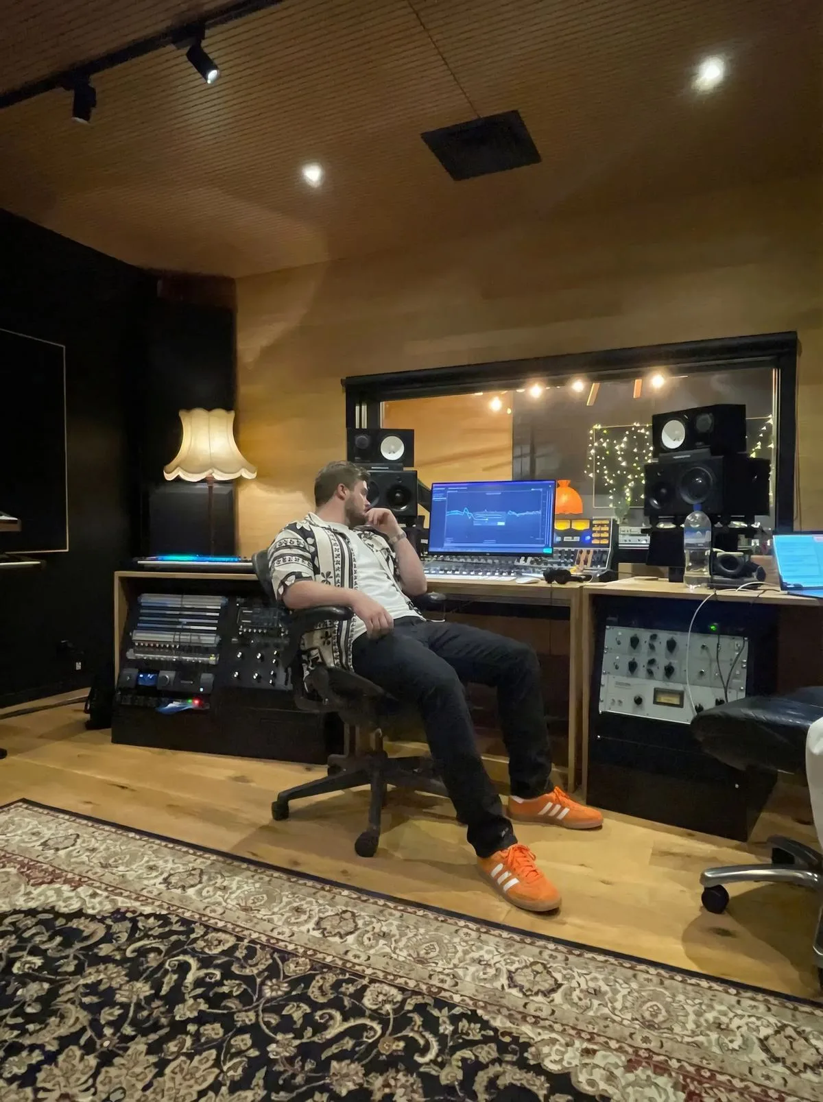 Ben in the control room, feet up, listening back